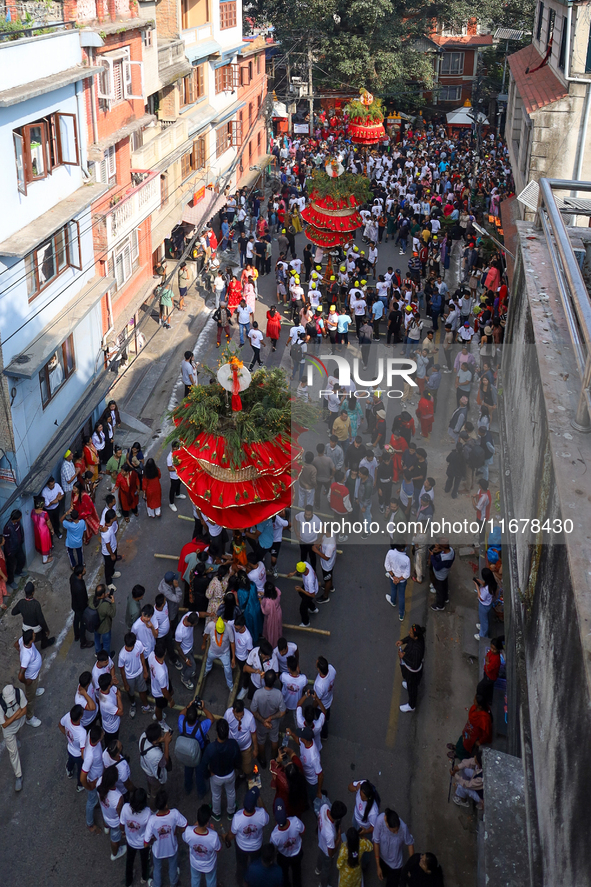 Devotees rotate the chariot of Lord Satya Narayan while celebrating the Hadigaun Jatra in Kathmandu, Nepal, on October 18, 2024. 