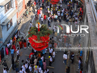 Devotees rotate the chariot of Lord Satya Narayan while celebrating the Hadigaun Jatra in Kathmandu, Nepal, on October 18, 2024. (