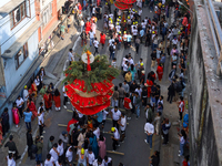 Devotees rotate the chariot of Lord Satya Narayan while celebrating the Hadigaun Jatra in Kathmandu, Nepal, on October 18, 2024. (