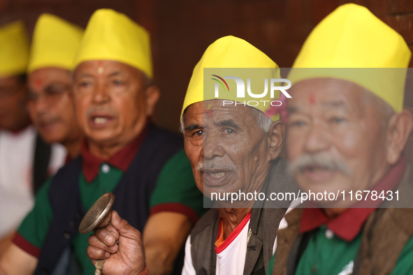 Elderly members of the local Newa: community sing hymns during Hadigaun Jatra in Kathmandu, Nepal, on October 18, 2024. 