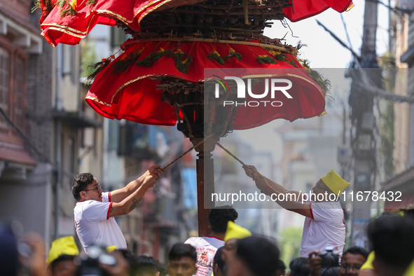 Devotees rotate the chariot of Lord Satya Narayan while celebrating the Hadigaun Jatra in Kathmandu, Nepal, on October 18, 2024. 