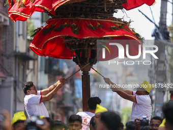 Devotees rotate the chariot of Lord Satya Narayan while celebrating the Hadigaun Jatra in Kathmandu, Nepal, on October 18, 2024. (