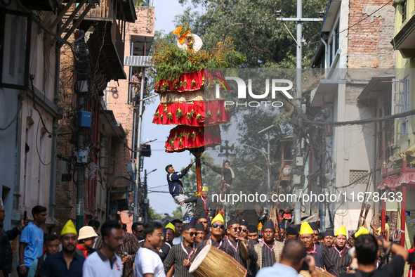 Devotees rotate the chariot of Lord Satya Narayan while celebrating the Hadigaun Jatra in Kathmandu, Nepal, on October 18, 2024. 