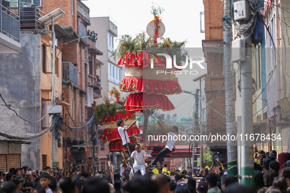 Devotees rotate the chariot of Lord Satya Narayan while celebrating the Hadigaun Jatra in Kathmandu, Nepal, on October 18, 2024. 