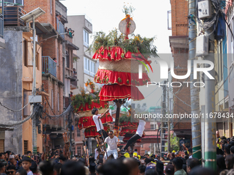 Devotees rotate the chariot of Lord Satya Narayan while celebrating the Hadigaun Jatra in Kathmandu, Nepal, on October 18, 2024. (