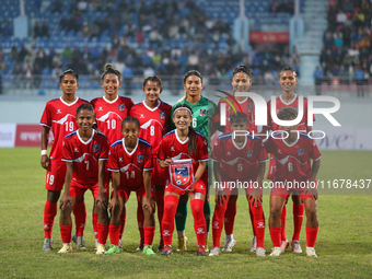 Team Nepal poses for a photo before the formal start of the match with Bhutan in the ongoing SAFF Women's Championship 2024 in Kathmandu, Ne...