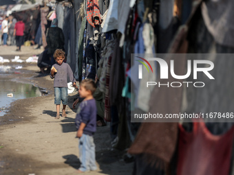 Displaced Palestinians are in Deir al-Balah in the central Gaza Strip on October 18, 2024, amid the ongoing war between Israel and the Pales...