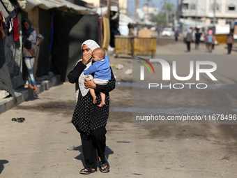 Displaced Palestinians are in Deir al-Balah in the central Gaza Strip on October 18, 2024, amid the ongoing war between Israel and the Pales...