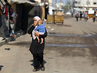 Displaced Palestinians are in Deir al-Balah in the central Gaza Strip on October 18, 2024, amid the ongoing war between Israel and the Pales...