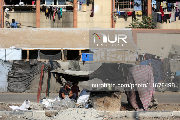 A Palestinian man bakes bread at a makeshift camp for the internally displaced in Deir al-Balah in the central Gaza Strip on October 18, 202...