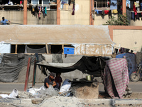 A Palestinian man bakes bread at a makeshift camp for the internally displaced in Deir al-Balah in the central Gaza Strip on October 18, 202...