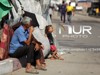 Displaced Palestinians are in Deir al-Balah in the central Gaza Strip on October 18, 2024, amid the ongoing war between Israel and the Pales...