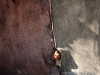 A Palestinian boy peeks from inside a tent at a makeshift camp for the internally displaced in Deir al-Balah in the central Gaza Strip on Oc...