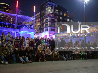 Spectators and participants are seen during the 2024 Blink Art and Light Festival in Cincinnati, Ohio, on October 17, 2024. (