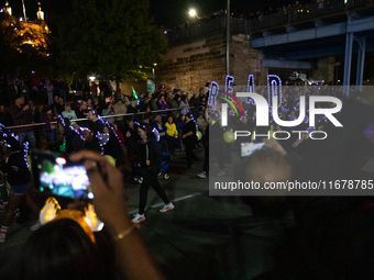 Spectators and participants are seen during the 2024 Blink Art and Light Festival in Cincinnati, Ohio, on October 17, 2024. (