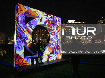 Spectators and participants are seen during the 2024 Blink Art and Light Festival in Cincinnati, Ohio, on October 17, 2024. (