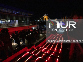 Spectators and participants are seen during the 2024 Blink Art and Light Festival in Cincinnati, Ohio, on October 17, 2024. (