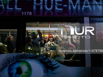 Spectators and participants are seen during the 2024 Blink Art and Light Festival in Cincinnati, Ohio, on October 17, 2024. (