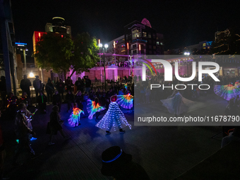 Spectators and participants are seen during the 2024 Blink Art and Light Festival in Cincinnati, Ohio, on October 17, 2024. (