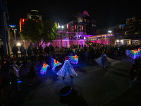 Spectators and participants are seen during the 2024 Blink Art and Light Festival in Cincinnati, Ohio, on October 17, 2024. (