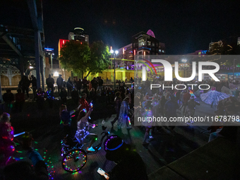 Spectators and participants are seen during the 2024 Blink Art and Light Festival in Cincinnati, Ohio, on October 17, 2024. (