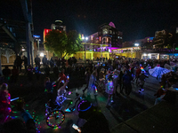 Spectators and participants are seen during the 2024 Blink Art and Light Festival in Cincinnati, Ohio, on October 17, 2024. (