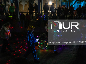 Spectators and participants are seen during the 2024 Blink Art and Light Festival in Cincinnati, Ohio, on October 17, 2024. (