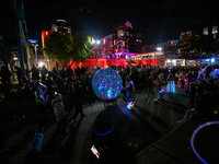 Spectators and participants are seen during the 2024 Blink Art and Light Festival in Cincinnati, Ohio, on October 17, 2024. (