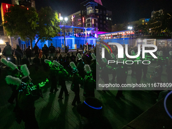 Spectators and participants are seen during the 2024 Blink Art and Light Festival in Cincinnati, Ohio, on October 17, 2024. (