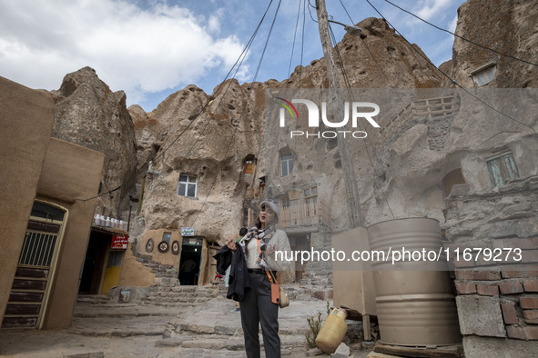 Iranian female blogger, Zahra Heidarpanah, known as Zarichii, sings an Iranian folklore song while visiting the Kandovan cliff village, 650...