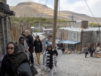 Iranian women visit the Kandovan cliff village, 650 km (400 miles) northwest of Tehran, Iran, on October 18, 2024. Kandovan is a village whe...