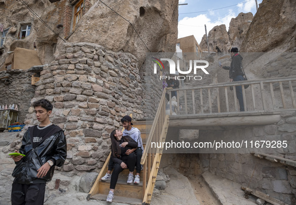 A young Iranian couple sits together while visiting the Kandovan cliff village, 650 km northwest of Tehran, Iran, on October 18, 2024. Kando...