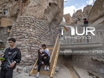 A young Iranian couple sits together while visiting the Kandovan cliff village, 650 km northwest of Tehran, Iran, on October 18, 2024. Kando...