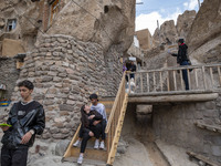 A young Iranian couple sits together while visiting the Kandovan cliff village, 650 km northwest of Tehran, Iran, on October 18, 2024. Kando...