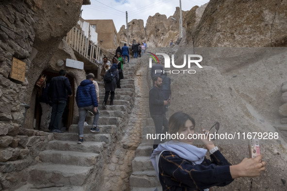 A young Iranian woman takes a selfie while visiting the Kandovan cliff village, 650 km northwest of Tehran, Iran, on October 18, 2024. Kando...