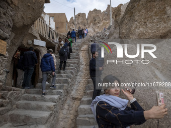 A young Iranian woman takes a selfie while visiting the Kandovan cliff village, 650 km northwest of Tehran, Iran, on October 18, 2024. Kando...