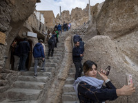 A young Iranian woman takes a selfie while visiting the Kandovan cliff village, 650 km northwest of Tehran, Iran, on October 18, 2024. Kando...