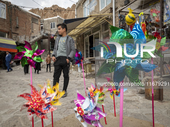 Pinwheels are placed on a sidewalk in Kandovan cliff village, 650 km (400 miles) northwest of Tehran, Iran, on October 18, 2024. Kandovan is...