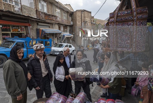 Iranian women shop for handicrafts while visiting Kandovan cliff village, located 650 km northwest of Tehran, Iran, on October 18, 2024. Kan...