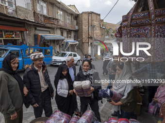 Iranian women shop for handicrafts while visiting Kandovan cliff village, located 650 km northwest of Tehran, Iran, on October 18, 2024. Kan...