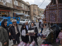 Iranian women shop for handicrafts while visiting Kandovan cliff village, located 650 km northwest of Tehran, Iran, on October 18, 2024. Kan...