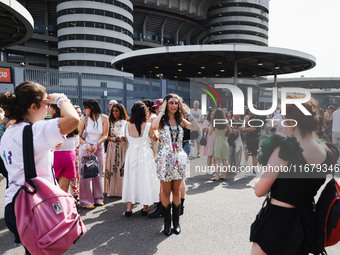 The audience attends Taylor Swift's The Eras Tour concert outside the Stadio San Siro in Milan, Italy, on July 13, 2024. (