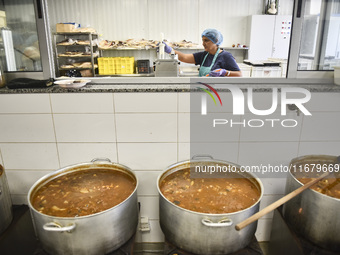 Lebanese volunteers prepare food portions for displaced people at Father Hani Tawk's charitable facility, Mariam's Kitchen, in Beirut, Leban...