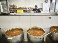 Lebanese volunteers prepare food portions for displaced people at Father Hani Tawk's charitable facility, Mariam's Kitchen, in Beirut, Leban...