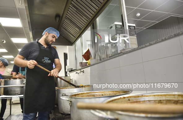 Lebanese volunteers prepare food portions for displaced people at Father Hani Tawk's charitable facility, Mariam's Kitchen, in Beirut, Leban...