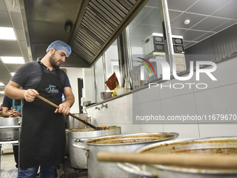 Lebanese volunteers prepare food portions for displaced people at Father Hani Tawk's charitable facility, Mariam's Kitchen, in Beirut, Leban...