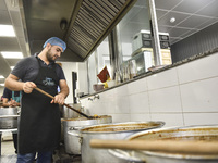 Lebanese volunteers prepare food portions for displaced people at Father Hani Tawk's charitable facility, Mariam's Kitchen, in Beirut, Leban...