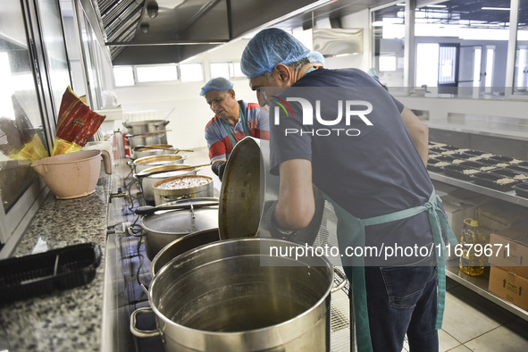 Lebanese volunteers prepare food portions for displaced people at Father Hani Tawk's charitable facility, Mariam's Kitchen, in Beirut, Leban...