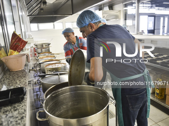 Lebanese volunteers prepare food portions for displaced people at Father Hani Tawk's charitable facility, Mariam's Kitchen, in Beirut, Leban...