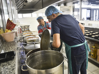 Lebanese volunteers prepare food portions for displaced people at Father Hani Tawk's charitable facility, Mariam's Kitchen, in Beirut, Leban...